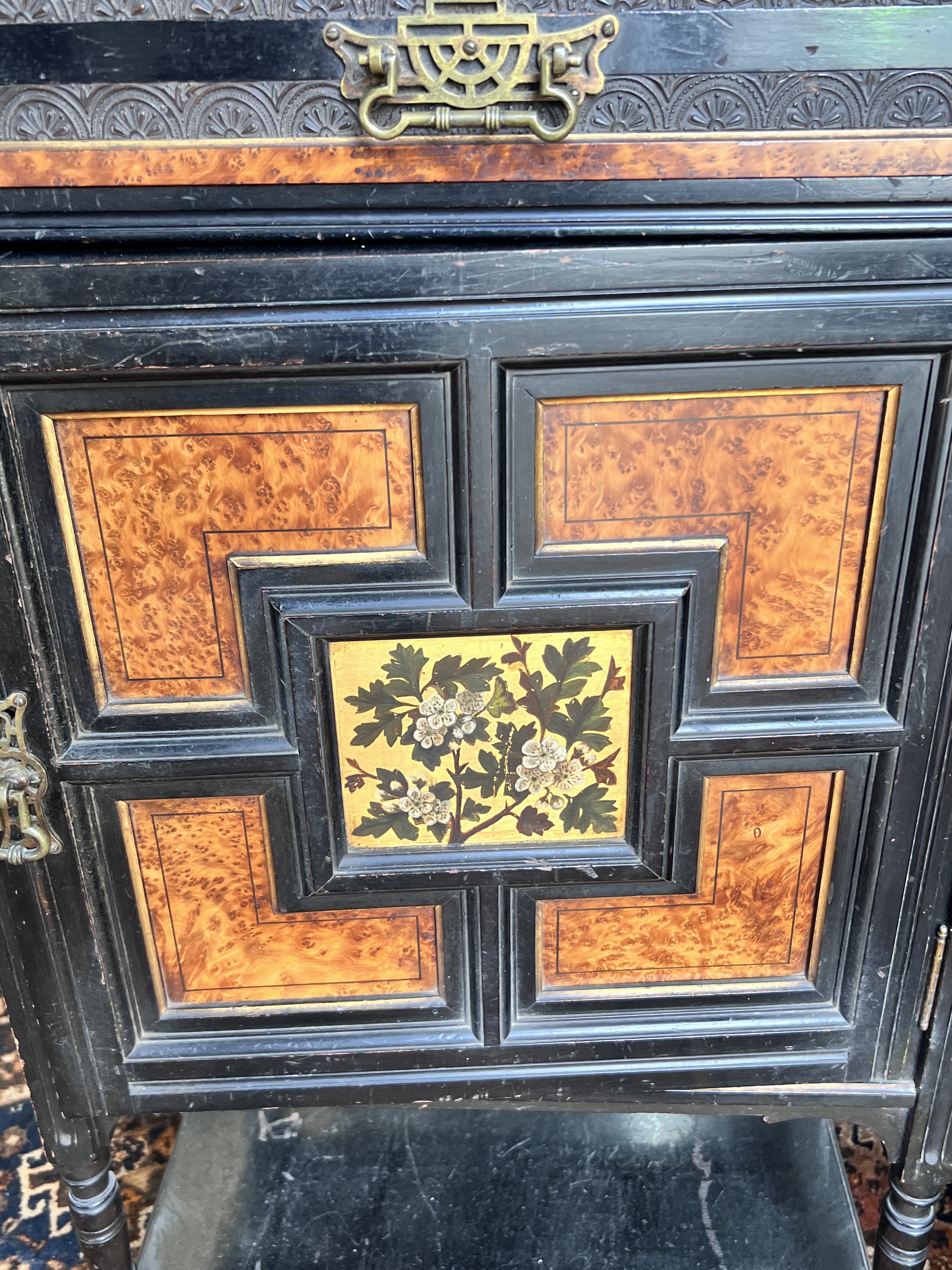 A late Victorian aesthetic movement ebonised amboyna side cabinet, width 55cm, depth 40cm, height 131cm